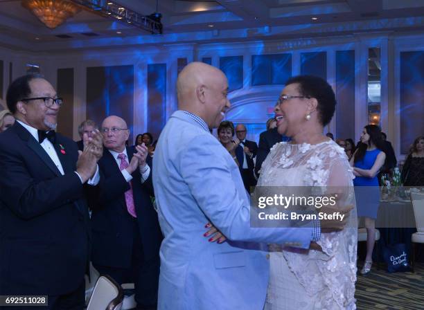 Diamond Empowerment Fund Co-Founders Dr. Ben Chavis and Russell Simmons congratulate humanitarian Graca Machel after she receives the "Diamonds Do...