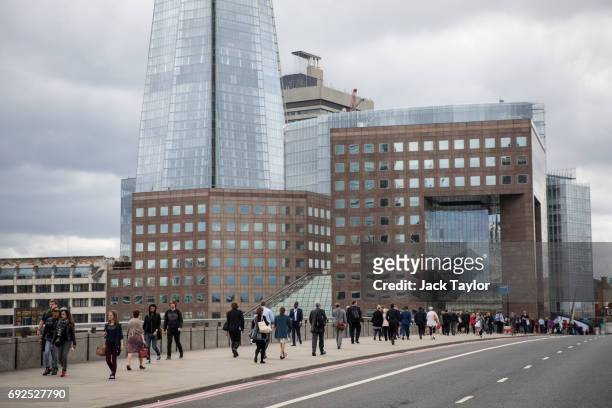 Commuters walk across London Bridge following the June 3rd terror attack on June 5, 2017 in London, England. Seven people were killed and at least 48...