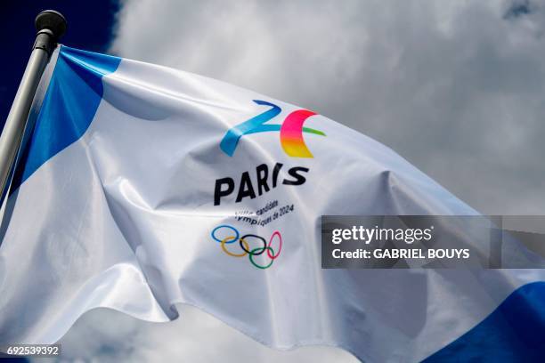 Flag to support the Paris bid for the 2024 Summer Olympics flutters during the Roland Garros 2017 French Open on June 5, 2017 in Paris.