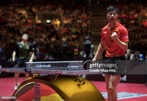 Ma Long of China celebrates against Zhendong Fan of China during Men's Singles Final at Table Tennis World Championship at Messe Duesseldorf on June...