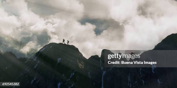 climbers on a rocky ridge. - challenger tour 2 stock pictures, royalty-free photos & images