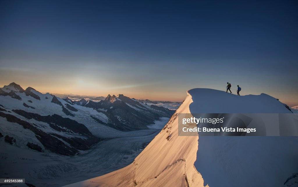 Climbers reaching the top of a mountain