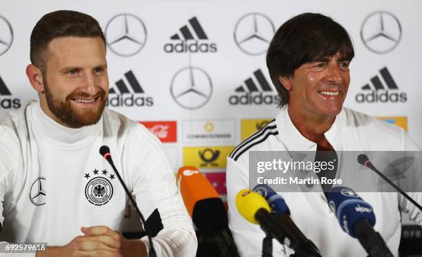 Joachim Loew head coach of Germany and Shkodran Mustafi smile during a Germany press conference ahead of their international friendly match against...