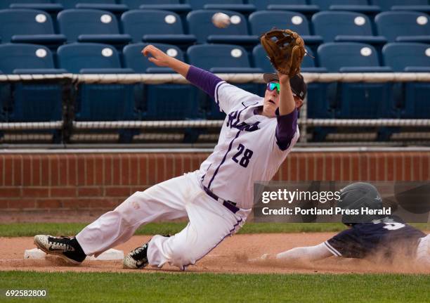 Deering third baseman Alex McGonagle dives off the base to catch an off the mark throw from the catcher as Portland baserunner Ben Stasium slides...