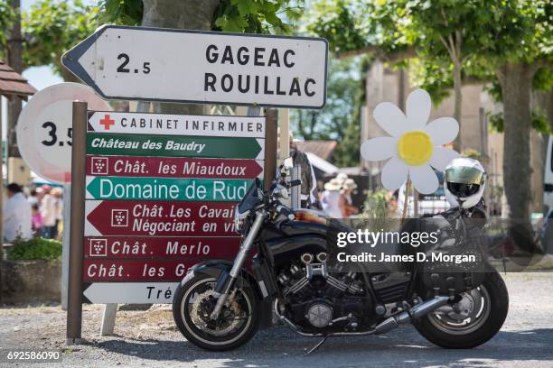 Homemade sunflowers made of cardboard and paper plates at a local fair on June 5, 2017 in Saussignac, France. Monday is a public holiday in France,...