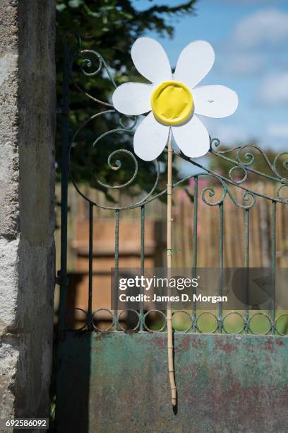 Homemade sunflowers made of cardboard and paper plates at a local fair on June 5, 2017 in Saussignac, France. Monday is a public holiday in France,...