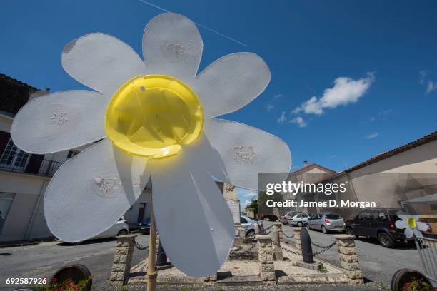 Homemade sunflowers made of cardboard and paper plates at a local fair on June 5, 2017 in Saussignac, France. Monday is a public holiday in France,...