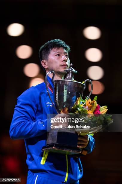 Ma Long of China holds the trophy after winning the Men's Singles Final match of the Table Tennis World Championship at Messe Duesseldorf on June 5,...