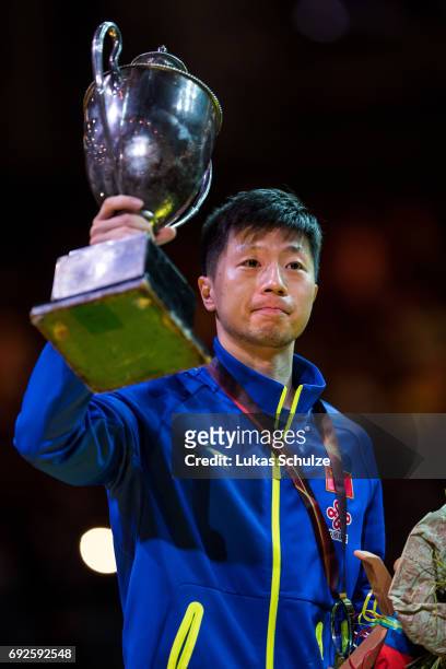 Ma Long of China holds the trophy after winning the Men's Singles Final match of the Table Tennis World Championship at Messe Duesseldorf on June 5,...
