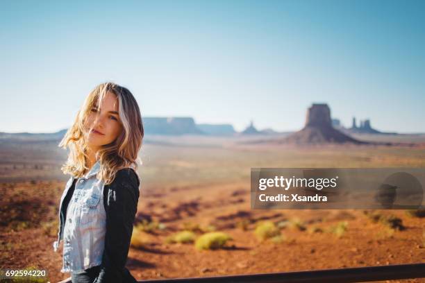 young woman at monument valley - mesa arizona stock pictures, royalty-free photos & images