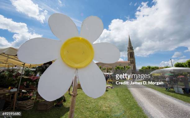 Homemade sunflowers made of cardboard and paper plates at a local fair on June 5, 2017 in Saussignac, France. Monday is a public holiday in France,...