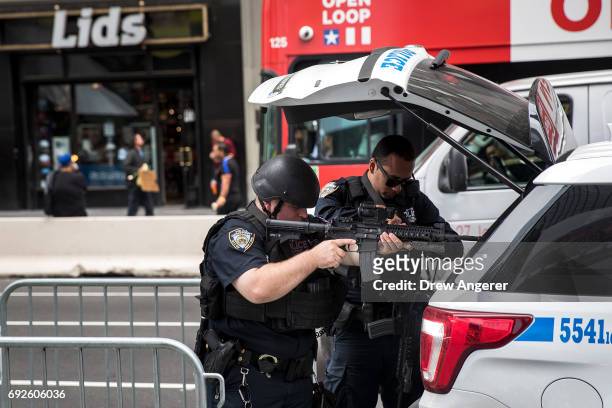 Members of the New York City Police Department's counterterrorism squad prepare their weapons in Times Square June 5, 2017 in New York City....