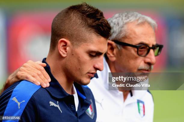 Marco Verratti of Italy and Italy Doctor Enrico Castellacci chat prior to the training session at Coverciano at Coverciano on June 05, 2017 in...