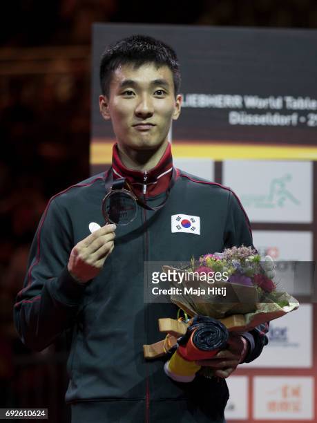 Sangsu Lee of South Korea celebrates with a bronze medal during celebration ceremony of Men's Singles Final at Table Tennis World Championship at...