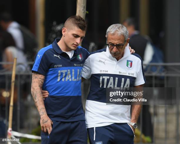 Marco Verratti of Italy and Italy Doctor Enrico Castellacci chat prior to the training session at Coverciano at Coverciano on June 05, 2017 in...