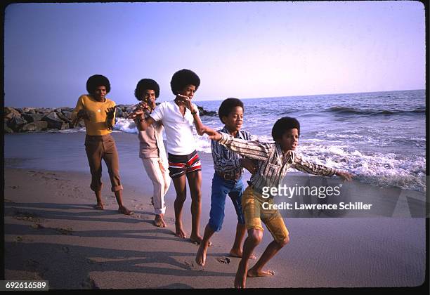Sibling American pop music group the Jackson 5 dance on a beach around the time of 'Diana Ross Presents the Jackson 5,' their debut album, Santa...