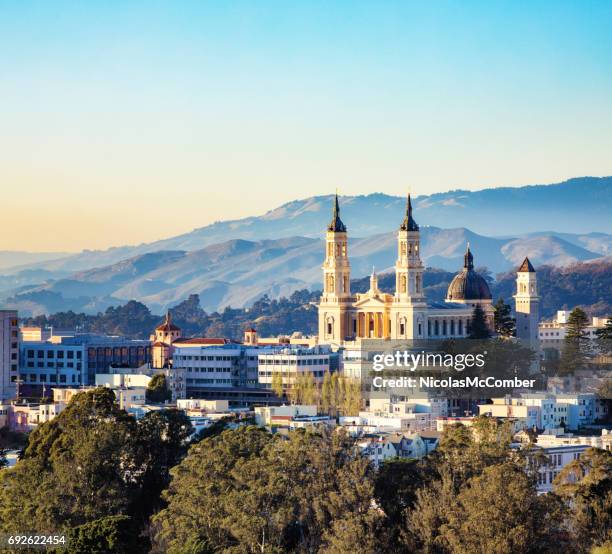 san francisco st. ignatius church en vista elevada del atardecer con colinas - parque de golden gate fotografías e imágenes de stock