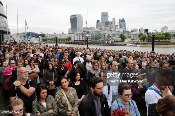 Members of the public take part in a vigil for the victims of the London Bridge terror attacks, in Potters Fields Park on June 5, 2017 in London,...