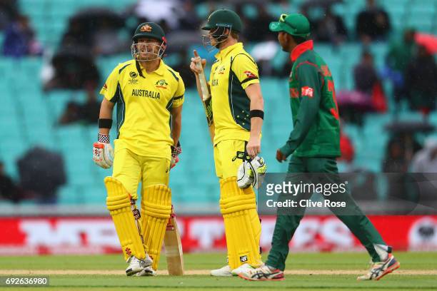Steven Smith and David Warner of Australia look on as play is suspended for rain during the ICC Champions trophy cricket match between Australia and...