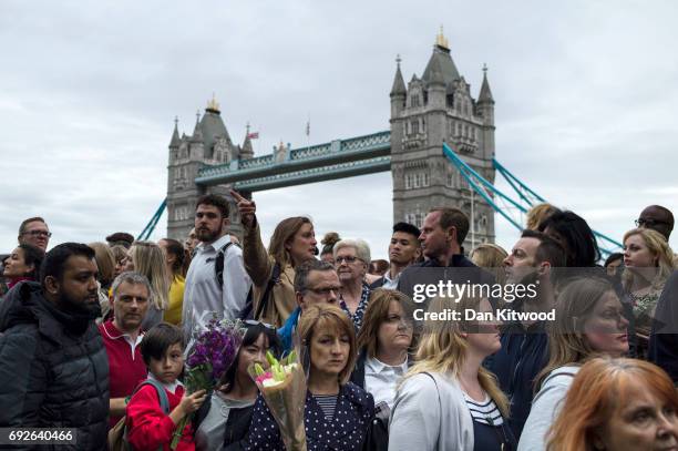 Members of the public take part in a vigil for the victims of the London Bridge terror attacks, in Potters Fields Park on June 5, 2017 in London,...