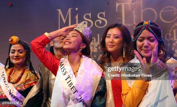 Tenzin Paldon flashes after winning the Miss Tibet 2017 title at Mcleodganj on June 4, 2017 near Dharamsala, India. Nine participants took part in...