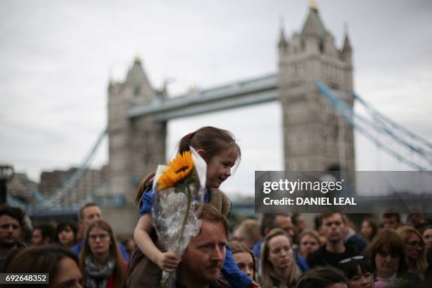 People gather for a vigil in Potters Fields Park in London on June 5, 2017 to commemorate the victims of the terror attack on London Bridge and at...