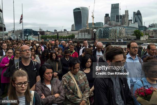 Members of the public take part in a vigil for the victims of the London Bridge terror attacks, in Potters Fields Park on June 5, 2017 in London,...