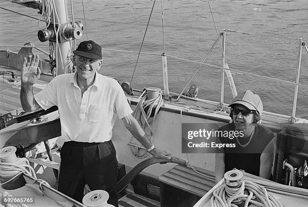 British yachtsman Francis Chichester and his wife Sheila sail out of the Pool of London on board his yacht, 'Gypsy Moth IV', 21st August 1966. From...