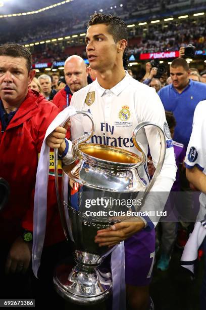 Cristiano Ronaldo of Real Madrid holds the trophy following the UEFA Champions League Final match between Juventus and Real Madrid at the National...