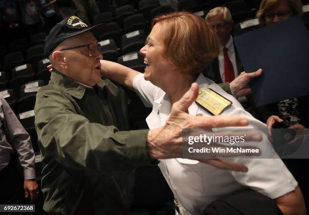 Battle of Midway veteran U.S. Navy retired Captain Jack Crawford is embraced by Rear Admiral Dawn Cutler during an event at the U.S. Naval Memorial...