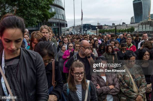 People observe a minute's silence during a vigil for the victims of the London Bridge terror attacks, in Potters Fields Park on June 5, 2017 in...