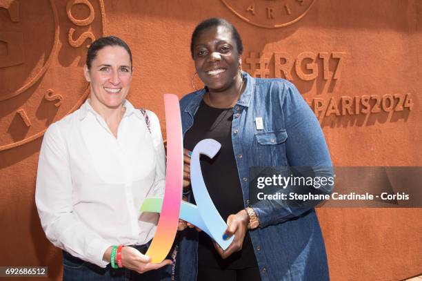 Laurence Fisher and Gwladys Epangue pose with the Paris 2024 Sign as they attend the 2017 French Tennis Open - Day Nine at Roland Garros on June 5,...