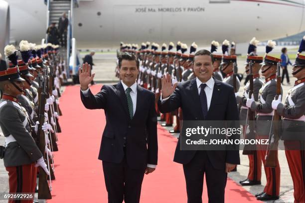 Mexican President Enrique Pena Nieto is welcomed by Guatemalan Foreign Minister Carlos Morales upon landing at the Guatemalan Air Force base in...