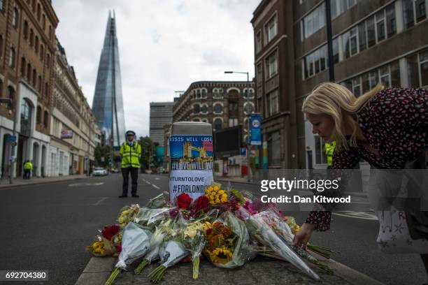 Member of the public lays flowers on the South side of London Bridge, close to Borough Market in London in tribute to the victims of the June 3...