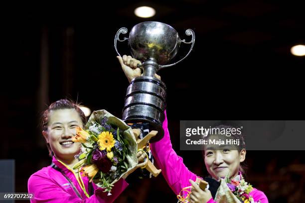 Ning Ding of China and Shiwen Liu of China celebrate with a trophy during celebration ceremony of Women's Doubles at Table Tennis World Championship...