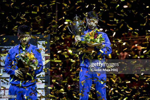 Ma Long of China holds a trophy next to Zhendong Fan of China during celebration ceremony of Men's Singles at Table Tennis World Championship at...