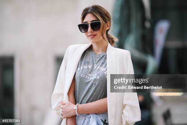 Bianca Derhy, fashion blogger Bibi Goes Chic, wears a Shein flower print skirt, a River Island gray top with the inscription "Saint Tropez", a Zara...