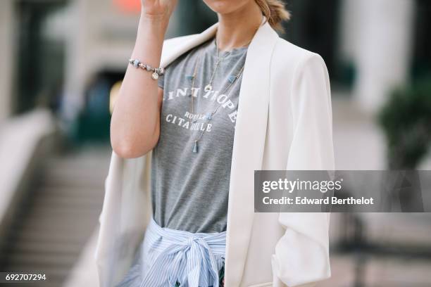 Bianca Derhy, fashion blogger Bibi Goes Chic, wears a Shein flower print skirt, a River Island gray top with the inscription "Saint Tropez", a Zara...