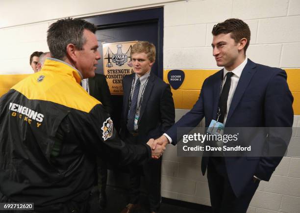 Top prospect Gabriel Vilardi shakes hands with head coach Mike Sullivan of the Pittsburgh Penguins as Casey Mittelstadt looks on during the media...