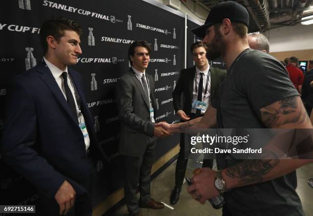 Austin Watson of the Nashville Predators shakes hands with top prospects Nico Hischier and Gabriel Vilardi during media availability for 2017 NHL...