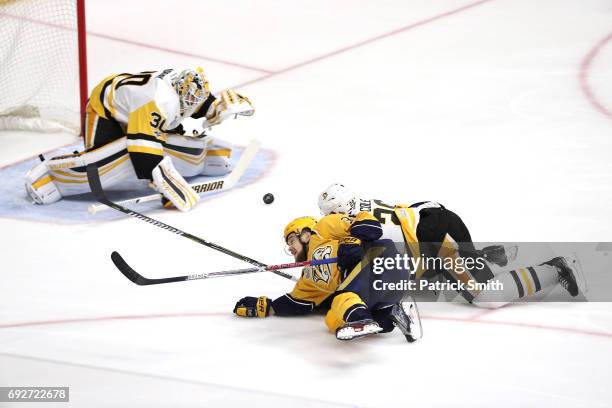 Matt Murray of the Pittsburgh Penguins makes a save as Viktor Arvidsson and Ian Cole of the Pittsburgh Penguins fall to the ice during the first...