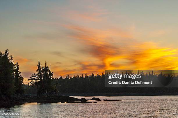 sunset reflection on water, inside passage, british columbia, canada - inside passage bc stock pictures, royalty-free photos & images
