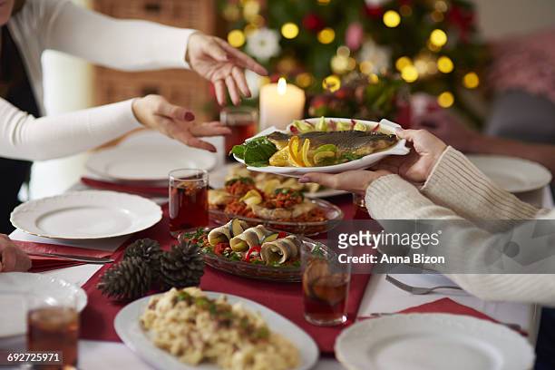 people passing plate with christmas carp. debica, poland - anna of poland stock pictures, royalty-free photos & images