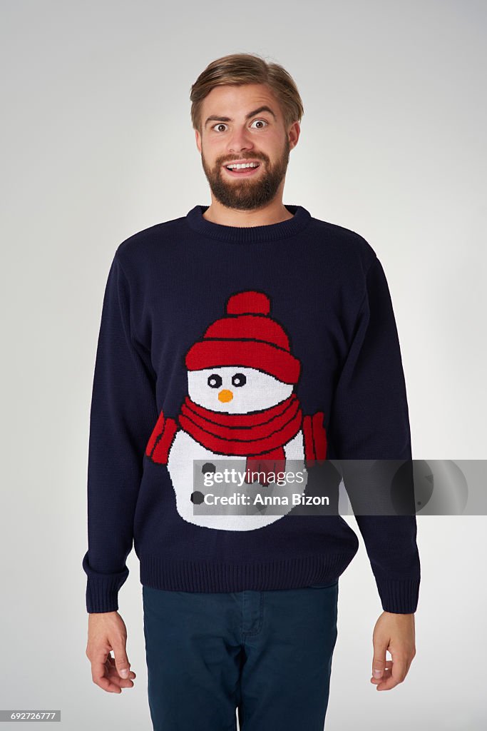 Man in Christmas jumper with a snowman. Debica, Poland. 