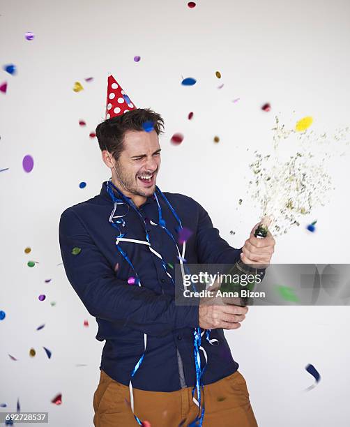 man opening a bottle of champagne. debica, poland - spraying champagne stock pictures, royalty-free photos & images