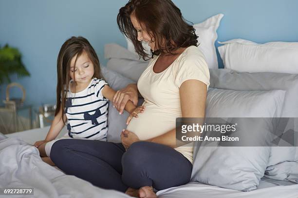 little girl touching her moms abdomen. debica, poland.  - anna of poland stock pictures, royalty-free photos & images