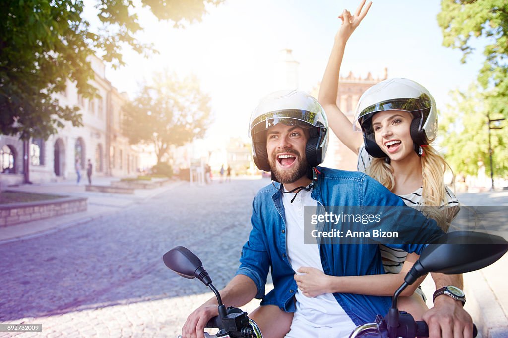 Couple riding a motorbike wearing helmets. Sandomierz, Poland. 
