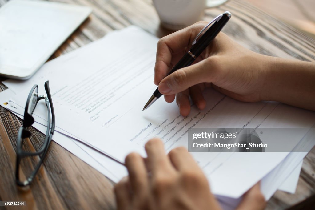 Businessman examining papers at table