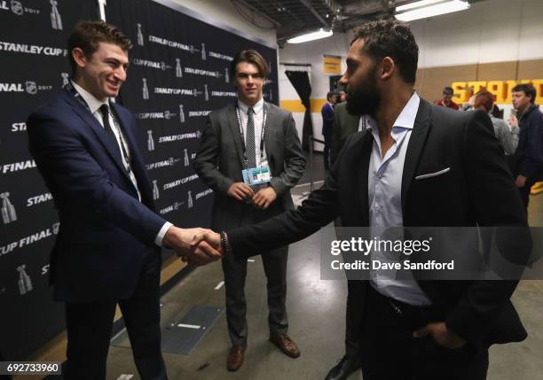 Trevor Daley of the Pittsburgh Penguins shakes hands with top prospects Nico Hischier and Gabriel Vilardi during media availability for 2017 NHL...