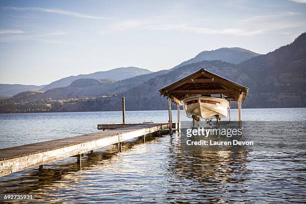 boat moored by pier, penticton, canada - penticton stock pictures, royalty-free photos & images